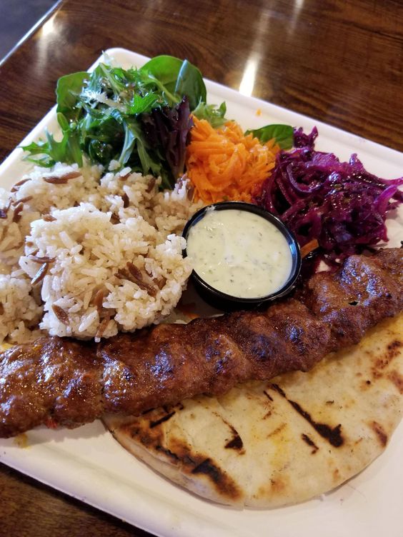 Adana kebab with pita bread and rice