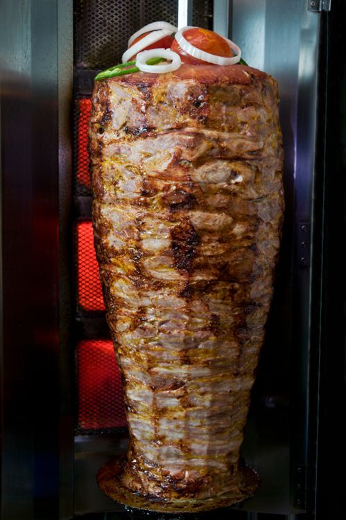 Doner kebab cooking process on the vertical giant skewer
